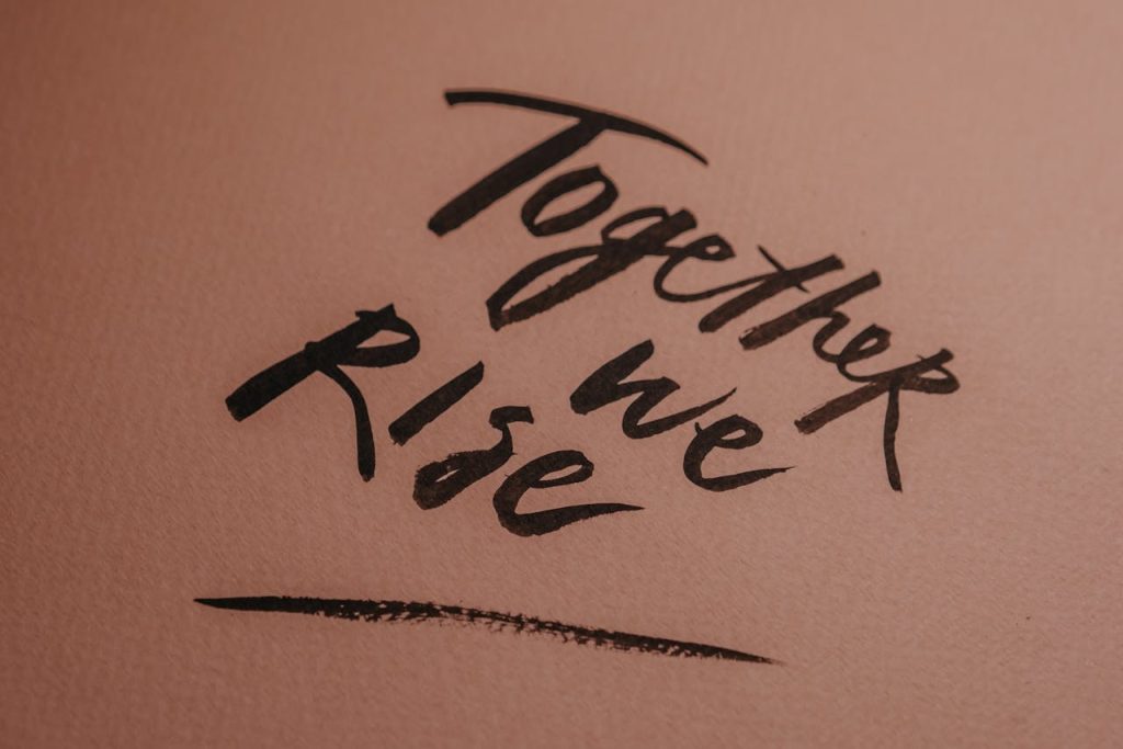 pexels-photo-6185558 Hand Lettering of the words Together We Rise